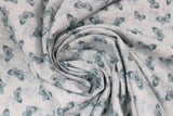 Swirled swatch forest themed fabric in Blue Butterflies (small blue butterflies on blue)