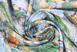 Swirled swatch river bottom blue fabric (medium blue and white water texture fabric with rocks and greenery)