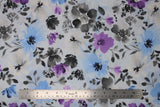 Flat swatch big floral watercolour fabric (white with large tossed floral in grey, light blue, and purple with watercolour effect)