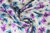Swirled swatch small floral watercolour fabric (white with small tossed floral in grey, blue, and purple with watercolour effect)