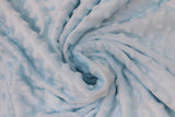 Swirled swatch baby blue solid coloured minky fabric with embossed dots