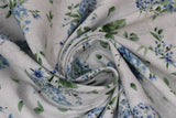 Swirled swatch Fresh Flowers White fabric (white fabric with tossed blue floral bouquets with some white floral and greenery, some in vases, and tossed green leaves)