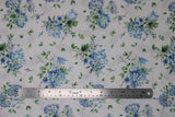 Flat swatch Fresh Flowers White fabric (white fabric with tossed blue floral bouquets with some white floral and greenery, some in vases, and tossed green leaves)