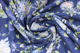Swirled swatch Fresh Flowers Navy fabric (navy fabric with tossed blue floral bouquets with some white floral and greenery, some in vases, and tossed green leaves)