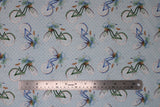 Flat swatch Bicycle fabric (pale blue fabric with tossed old style blue bikes with brown baskets filled with blue and white floral with greenery and leaves)