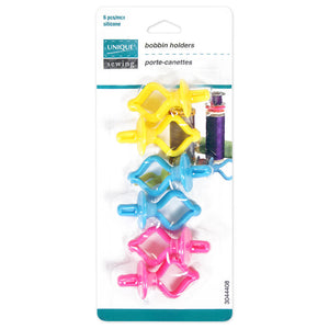 Package of 6 plastic bobbin holders (2 yellow, 2 blue, 2 pink) on white background