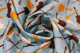 Swirled swatch Blue Toss fabric (blue fabric with tossed music instrument silhouettes in cream, black and gold)