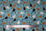 Flat swatch Blue Toss fabric (blue fabric with tossed music instrument silhouettes in cream, black and gold)