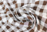 Swirled swatch brown and white medium sized gingham print fabric