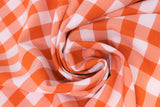 Swirled swatch orange and white medium sized gingham print fabric