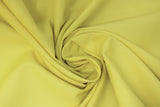 Swirled swatch Broadcloth Solid fabric in shade Western Yellow (bright yellow/green)