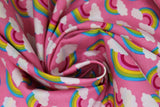 Swirled swatch Pink Rainbow fabric (bubblegum pink fabric with rainbow arches with white clouds on both ends allover)