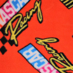 Square swatch Nascar Retro Racing Flags fabric (red fabric with large loosely tossed nascar text logos with vintage rainbow style flag)