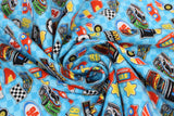 Swirled swatch Nascar Icons fabric (light blue checkered fabric with tossed nascar emblems allover in full colour illustrative style: cars, logo, flags, gas, stars, etc.)
