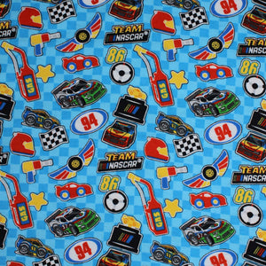 Square swatch Nascar Icons fabric (light blue checkered fabric with tossed nascar emblems allover in full colour illustrative style: cars, logo, flags, gas, stars, etc.)
