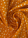 Swirled swatch microprint flannel in dainty flowers on orange (white tiny flower heads)