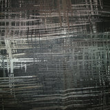 Square swatch weathered look/print upholstery fabric in shade black base (black with grey shades of distressing pattern)