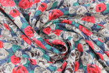 Swirled swatch grey/red flowers fabric (dark grey fabric with busy collaged rose look illustrative floral heads allover in light grey, red, with green leaves)