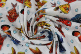 Swirled swatch digital printed fabric in fish (white fabric with drawn gold, red, and clown fish with blue bubbles and dark blue sea plant)