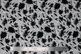 Flat swatch digital printed fabric in black flowers (white fabric with black tossed floral and flowy stems allover)