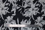 Flat swatch black palma print (black fabric with large white drawn look large floral heads and thin stems)
