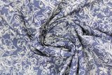 Swirled swatch denim look fabric with floral designs in dark (dark blue fabric with white busy floral drawing allover)