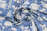 Swirled swatch denim look fabric with floral designs in light (light blue fabric with white tossed floral and stems)