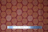 Flat swatch Flower Burst fabric (burgundy fabric with pale orange and brown/red floral petal burst circles allover with grey center dots)
