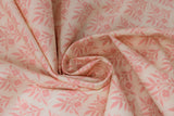 Swirled swatch Sweet Scroll Pink fabric (pale pink fabric with loosely packed pink floral and stems in square shapes repeated allover to make diagonal lines)