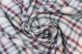 Swirled swatch organic cotton/hemp blend flannel in plaid pattern with green, red, blue lines on white and beige