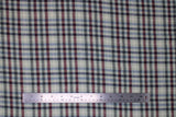 Flat swatch organic cotton/hemp blend flannel in plaid pattern with green, red, blue lines on white and beige