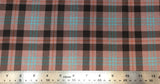 Flat swatch highland tartan printed fabric in tan (tan fabric with black, red, light blue plaid lines)