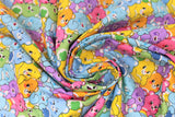 Swirled swatch care bear printed fabric in believe believers (colourful care bear collage allover)