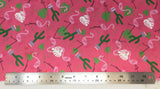 Flat swatch cartoon flamingos and cactus printed fabric in pink (bright bubblegum pink fabric with tossed cartoon pink flamingos, white and green leaves, green cactus in pink planter)