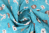 Swirled swatch friends fabric (bright teal blue fabric with cross hatch style lines allover in background, tossed medium sized nordic friends heads cartoon style in colour: penguin, bunny, polar bear, walrus, etc.)