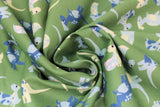 Swirled swatch green fabric (medium green fabric with small tossed cartoon style dinosaurs in green and blue shades allover)