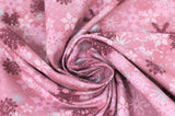 Swirled swatch Pink Snowflakes fabric (medium pink marbled look fabric with tossed snowflakes allover in various sizes, styles, and shades of pink, burgundy and silver metallic effect)