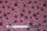 Flat swatch Pink Snowflakes fabric (medium pink marbled look fabric with tossed snowflakes allover in various sizes, styles, and shades of pink, burgundy and silver metallic effect)