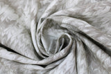 Swirled swatch Parchment Feathers fabric (white fabric with faded beige grey chevron feather look design)