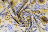 Swirled swatch assorted bee printed fabric in busy bees and sunflowers (pale yellow fabric with tossed yellow sunflower heads, blue leaves and swoopy greenery, bumblebees tossed)