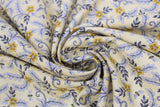 Swirled swatch assorted bee printed fabric in busy bees yellow (pale yellow fabric with tossed small yellow flower heads and yellow tiny bees and blue leaves allover)