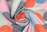 Swirled swatch natural wool fabric (grey fabric with horizontal stripes of circular balls of yarn in orange, blue, charcoal, pink, light blue, light grey, alternating)
