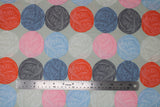 Flat swatch natural wool fabric (grey fabric with horizontal stripes of circular balls of yarn in orange, blue, charcoal, pink, light blue, light grey, alternating)