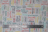 Flat swatch Words White fabric (white fabric with tossed cat-related words and phrases allover in multi directions and various colours: "CATitude" "Purr-fect" etc.)