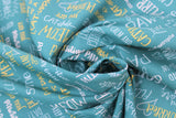 Swirled swatch Words Blue fabric (turquoise blue fabric with tossed cat-related words and phrases allover in multi directions and various colours: "CATitude" "Purr-fect" etc.)