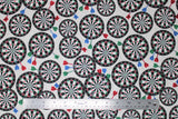 Flat swatch man cave themed fabric in darts white (white fabric with tossed dart boards assorted sizes with red/blue/green darts)