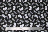 Flat swatch man cave themed fabric in video games black (black fabric with assorted small grey cartoon video game controllers and remotes tossed)