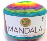 A cake of Lion Brand Mandala yarn in colourway gnome (blue, pale green, purple, pink, orange, yellow)