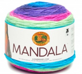 A cake of Lion Brand Mandala yarn in colourway troll (bright blue, purple, hot pink, pale lime)