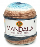 A cake of Lion Brand Mandala Baby yarn in colourway wishing well (white, baby blue, dark faded blue, medium grey, tan)